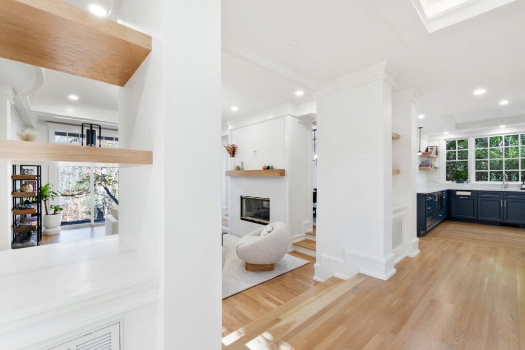 Open plan entry, living room and kitchen after a whole home renovation by CoCreations Homes