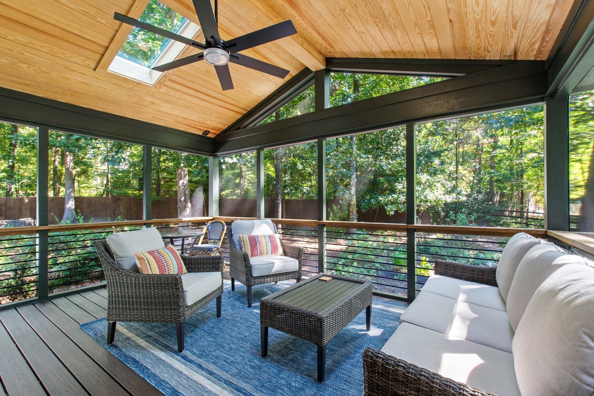 NW 10th St Ankeny 12 | CoCreations Construction & Design | CoCreations Construction & Design Screened porch with wood ceiling, cushioned seating, and wooded view | CoCreations Construction & Design | CoCreations Construction & Design